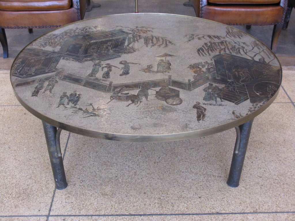 Philip and Kelvin Laverne coffee table.  Round patinated bronze, pewter and enamel top with acid-etched decoration of traditional Japanese figures over antique brass legs with arched supports.  Signed in top surface 