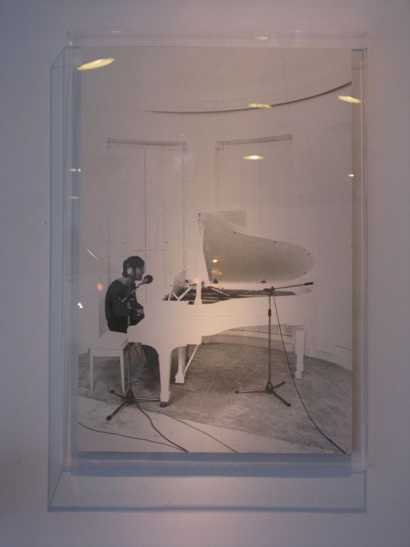 Original black & white print featuring John Lennon at his white grand piano.  The photo was taken in 1971 by Peter Fordham at John & Yoko's estate in Tittenhurst, Ascot during the 