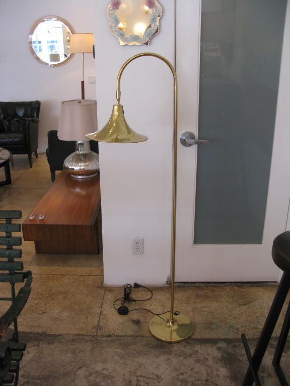 Brass floor lamp designed by Borje Claes.  Adjustable head.