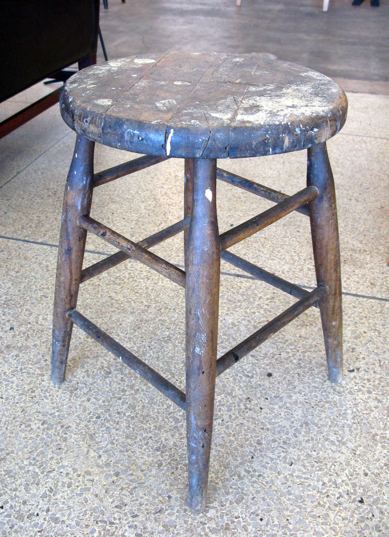 Very old wooden milking stool with wire brace under seat.  Lots of great patina & character from age.