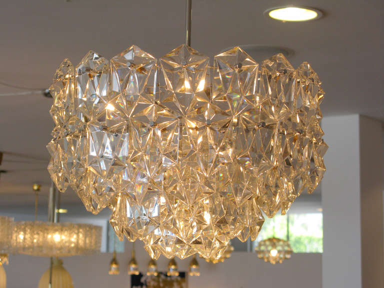 Stunning 5-tiered, clear faceted crystal chandelier by Kinkeldey Leuchten of Germany.  Polished nickel hardware.  13 light bulbs.

*** ON SALE.  50% off list price until AUGUST 31, 2014.  The price shown already reflects the 50% discount ***