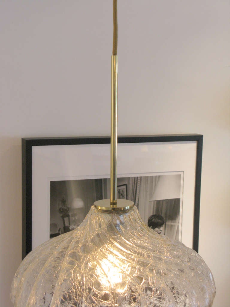 Clear crackled glass pendant light by Doria of Germany.  Light has a unique natural and golden woven cord.  Single Edison bulb gives off a warm glow.

