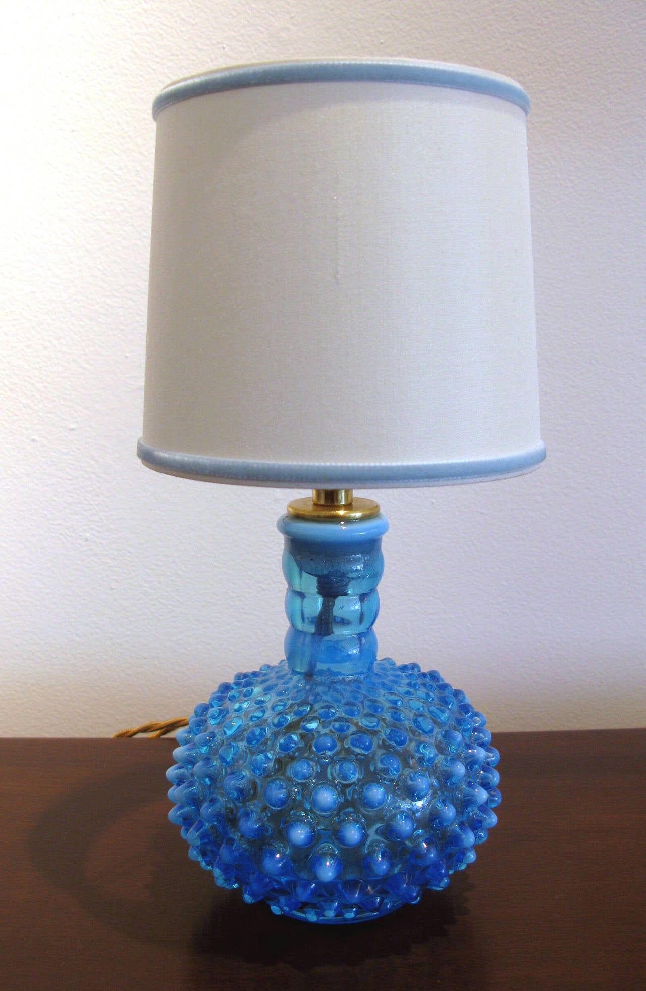 Pair of petite aqua blue and white opalescent hobnail glass lamps. Designed and produced by Fenton Art Glass. New silk shades with baby blue velvet trim. Gold cord and brass sockets. Dimensions shown include shades.