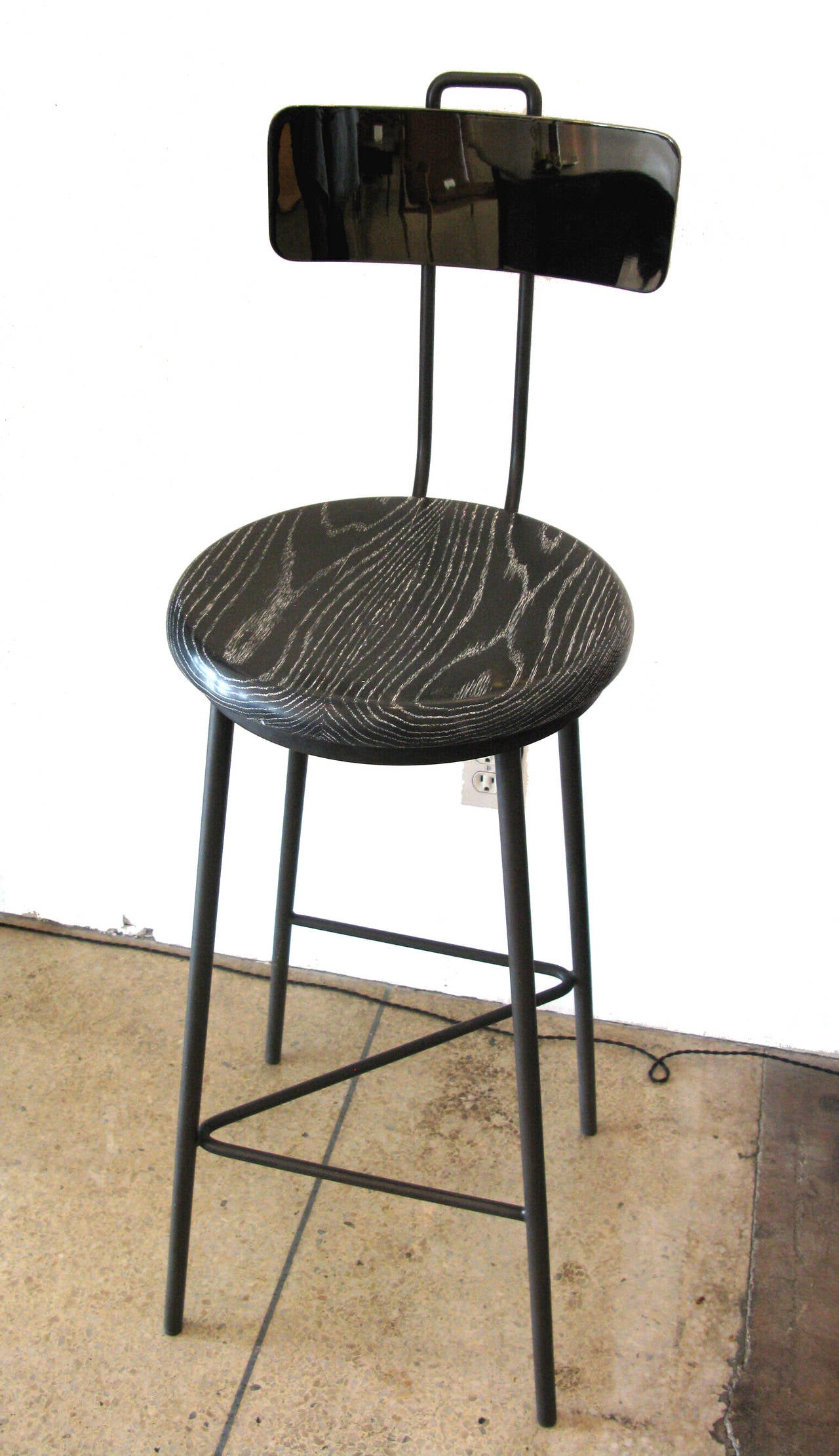 Matte oxidized black metal frame with an articulating backrest in polished black nickel. Base features a 