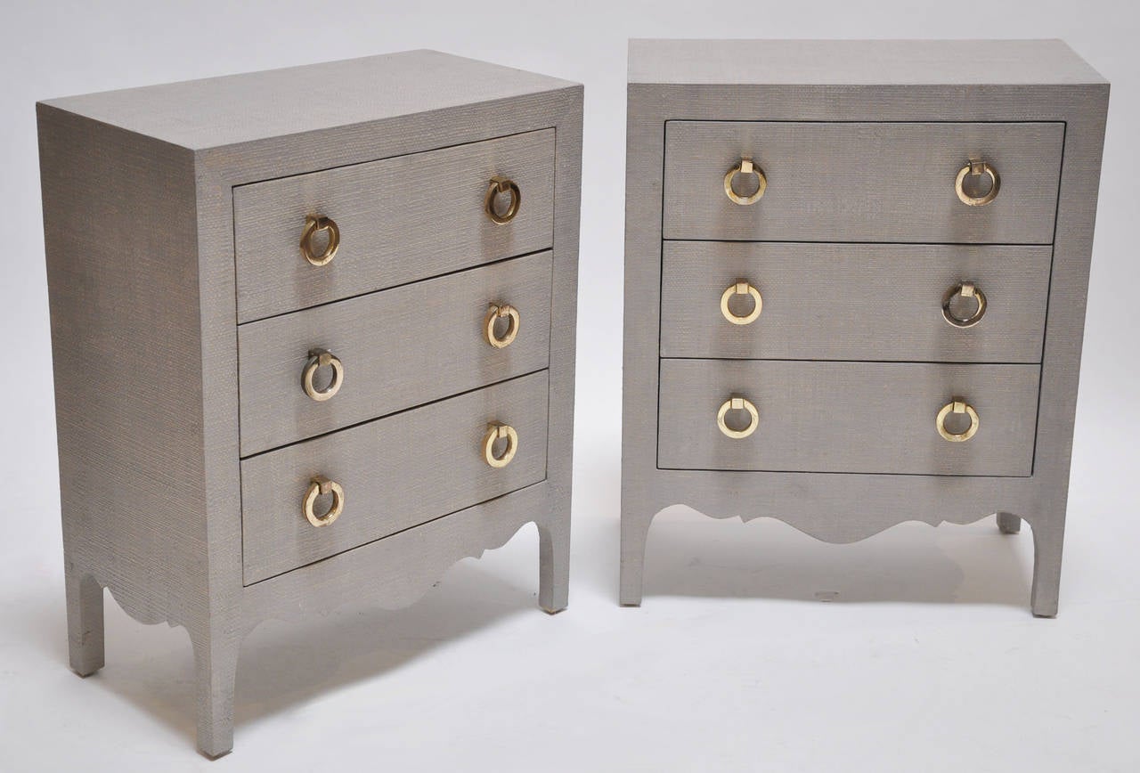 Pair of small grasscloth clad dressers or nightstands, each with four drawers and brass pulls. The interior of the drawers feature finished mahogany. Finished on all sides. Fine quality with attention to detail. Price is for the pair.