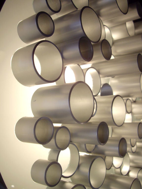 Illuminated wall sculpture by Angelo Brotto for Esperia. Both polished and brushed steel. Glass background with the light source inside. Top quality design and construction.