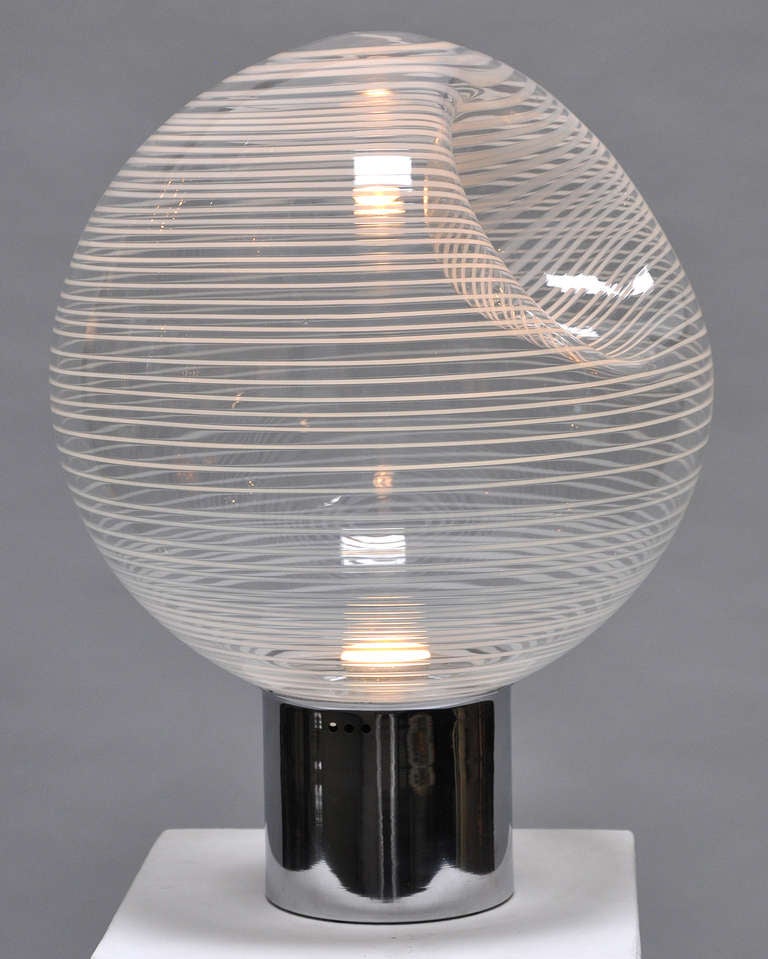 Clear and white blown glass table lamp by Vistosi. Polished steel base. 