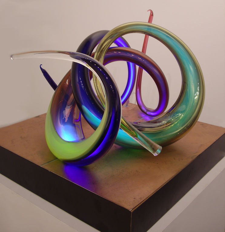 Illuminated glass sculpture by American glass artist Paul Seide. Sculpted blown glass tubes with captured gas inside are illuminated by radio waves eminating from the base. The base acts as an antena and is connected to a radio box. <br />
Paul