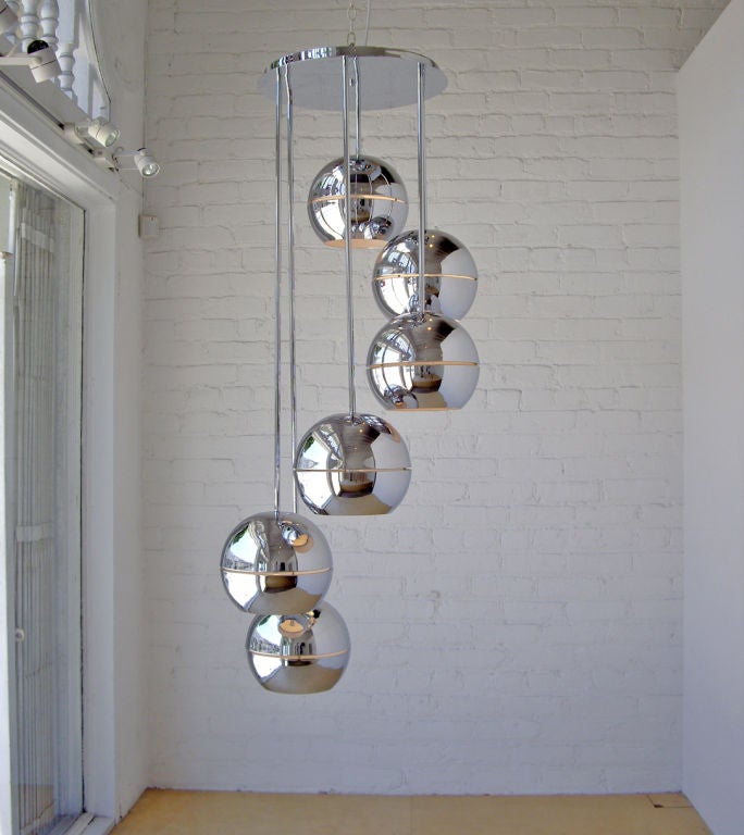 Hanging ceiling light made with six polished chrome balls that spriral down from the center plate. The top plate (17.5