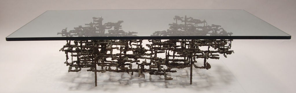 Welded steel and glass coffee table. Abstract metal base with 3/4