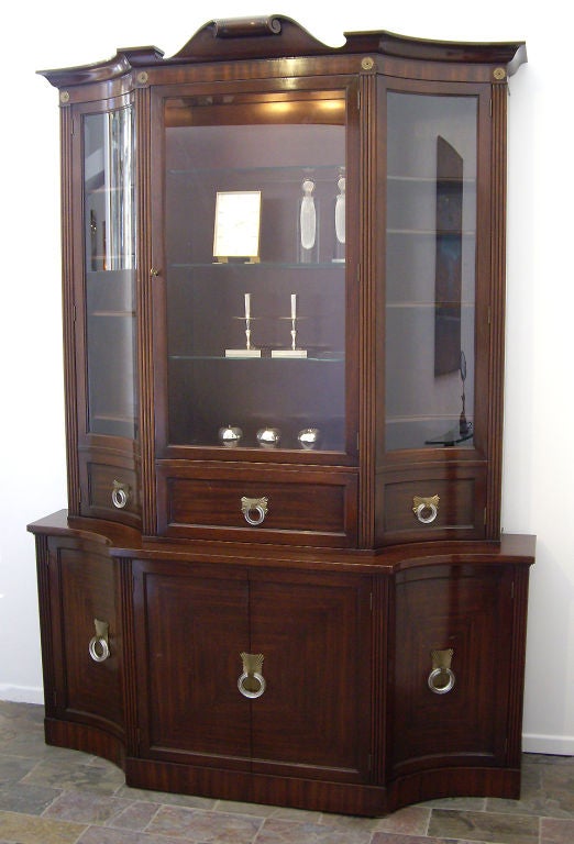 Beautiful original Grosfeld House cabinet with a pull-out desk and a tooled leather writing surface. Other features include interior lights, glass shelves, Lucite pulls and the original key. The cabinet is in two parts. Top and bottom.