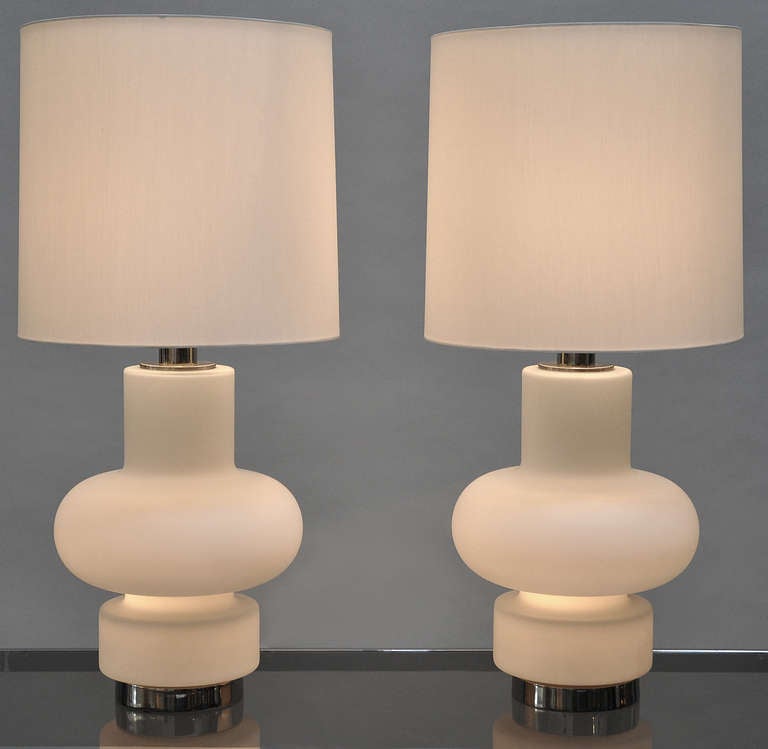 Pair of white glass lamps by Bobo Piccoli for Fontana Arte.
The glass bases illuminate separately from the top. Light the top, the bottom, or both. 
Includes custom silk lampshades. Price is for the pair.