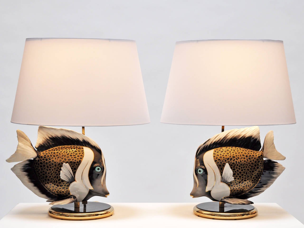 Pair of 1970s porcelain fish lamps. Signed Italy. The quality and details are exquisite. New custom oval silk shades with diffusers. 
Price is for the pair. Shades measure: 20