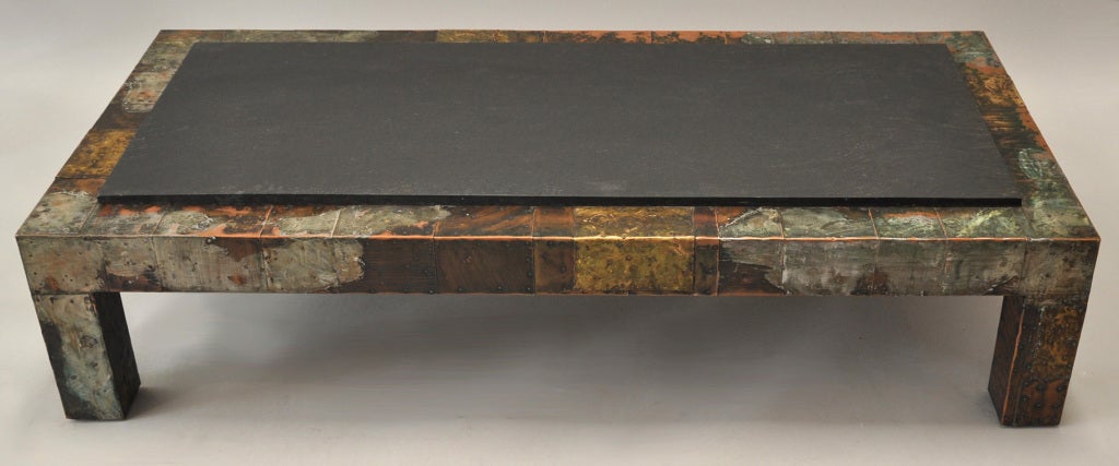 Large handsome coffee table by American artist and craftsman Paul Evans. Slate top with patchwork metal. Purchased from Directional in 1972.