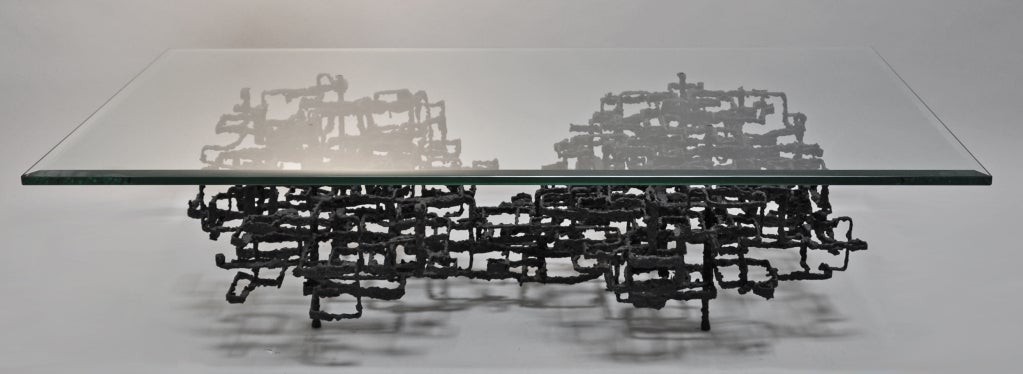 Welded steel and glass coffee table. Abstract metal base with 3/4