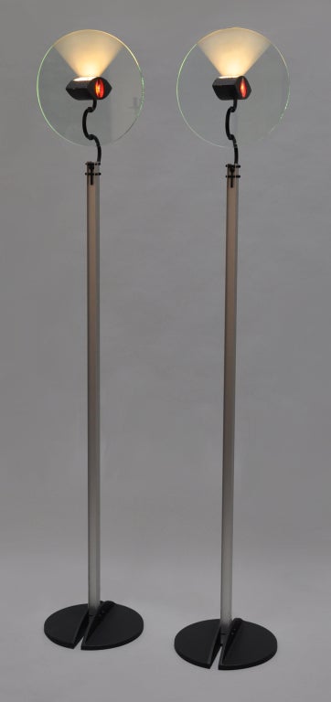 Pair of Olympia floor lamps designed by 
Carlo Forcolini for Artimede. The lighted portion pivots from side to side. 
Price is for the pair.