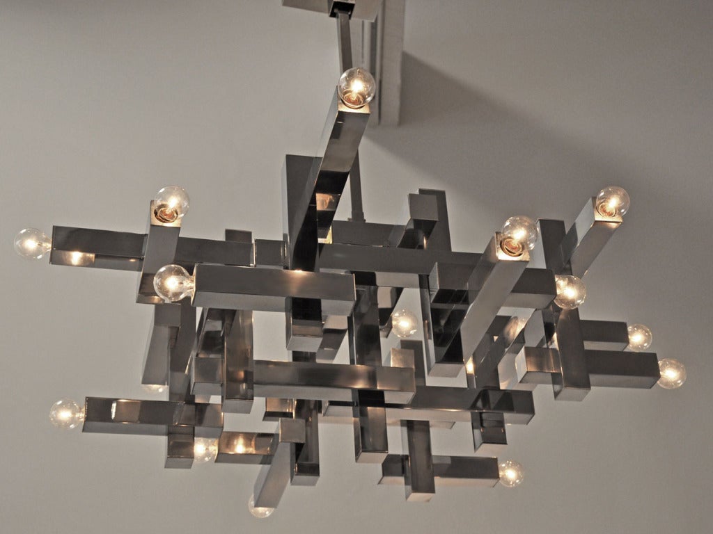Gaetano Sciolari eighteen light chandelier. This reflective light is a facinating architectural design.
Retains original paper label: Sciolari.  As shown from top to bottom: 33.5