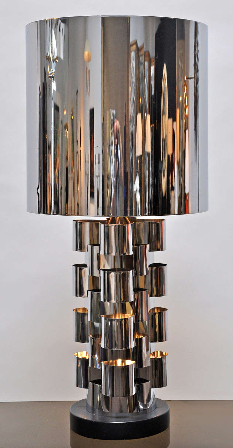 Large table lamp signed C. Jere. Features a three way switch in the top portion with additional illumination in the base. One or both light sourcescan be used at the same time. Quality construction is polished chrome over steel.