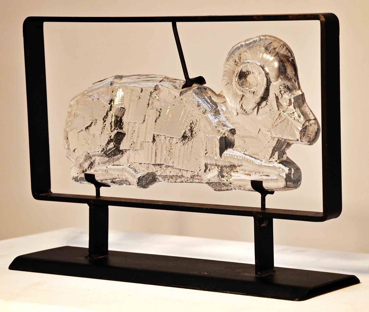 Swedish modernist design. Glass sculpture in the shape of a ram. Designed by Erik Höglund and produced in cooperation with Boda blacksmith. The glass is held in place by the iron frame.
Erik Höglund (b.Sweden 1932- 1998.) He is best known for his