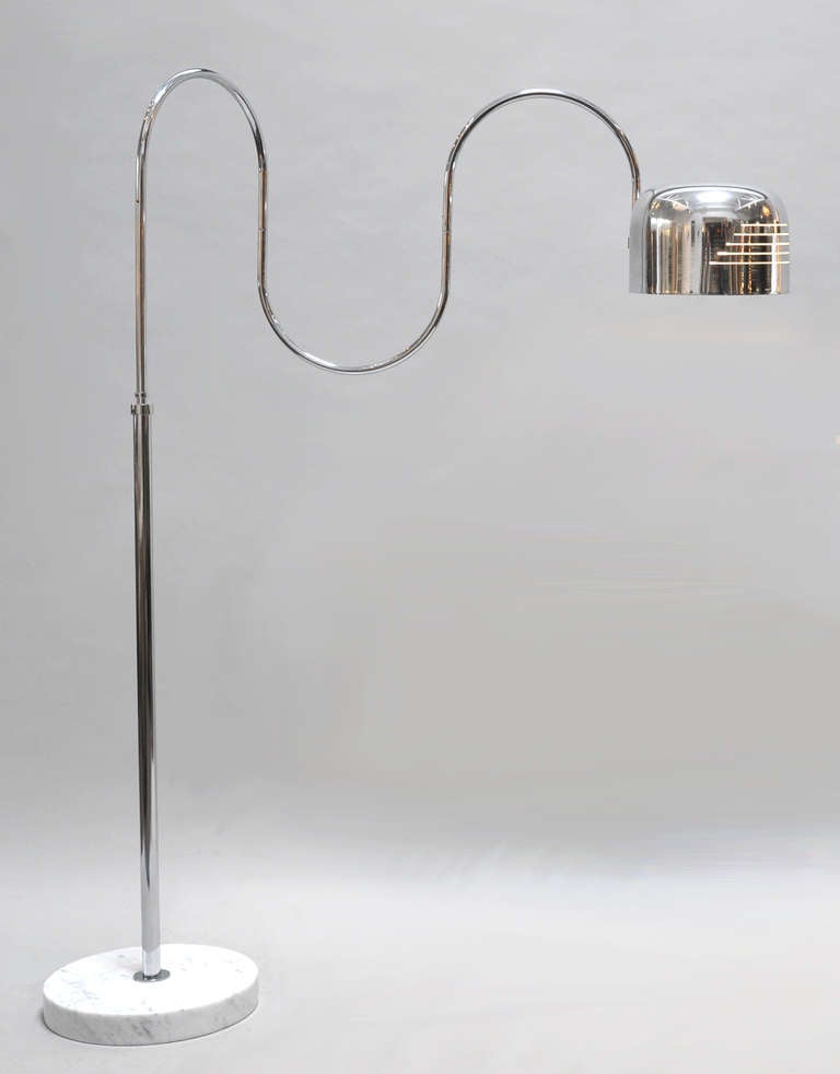 Fully adjustable floor lamp. Made in Italy for Mutual Sunset Lamp Company. Features a marble base and polished aluminum shade and supporting parts. The height adjusts from 59