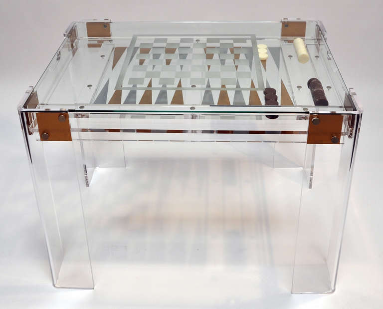 Heavy clear Lucite game table. Glass top is etched for playing a game of chess or checkers. The glass top is removable for playing backgammon.  Top quality design and construction.