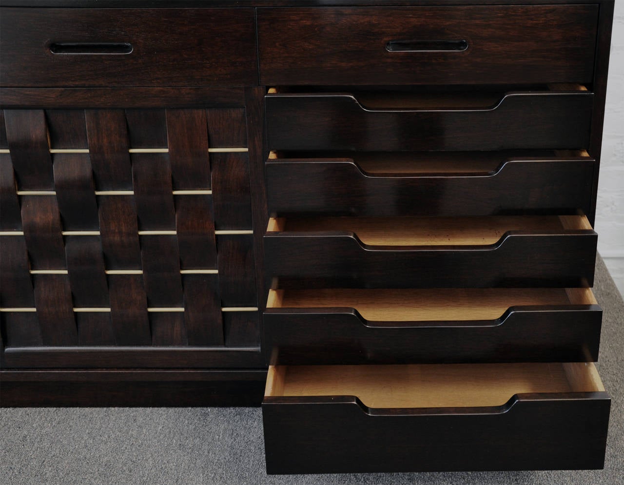 Large sideboard designed by Edward Wormley for Dunbar Furniture Company, Berne, Indiana. Dark walnut case with beautiful original hand rubbed finish. Four top drawers have recessed handle grips. Four sliding doors of laminated walnut veneer