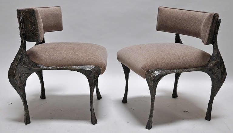Produced in 1969, this pair of dining or occasional chairs, were made in the Evans studio and were designed by Paul Evans. The chairs are comfortable and newly upholstered.  The frames are made of steel, covered with the Evans signature sculpted