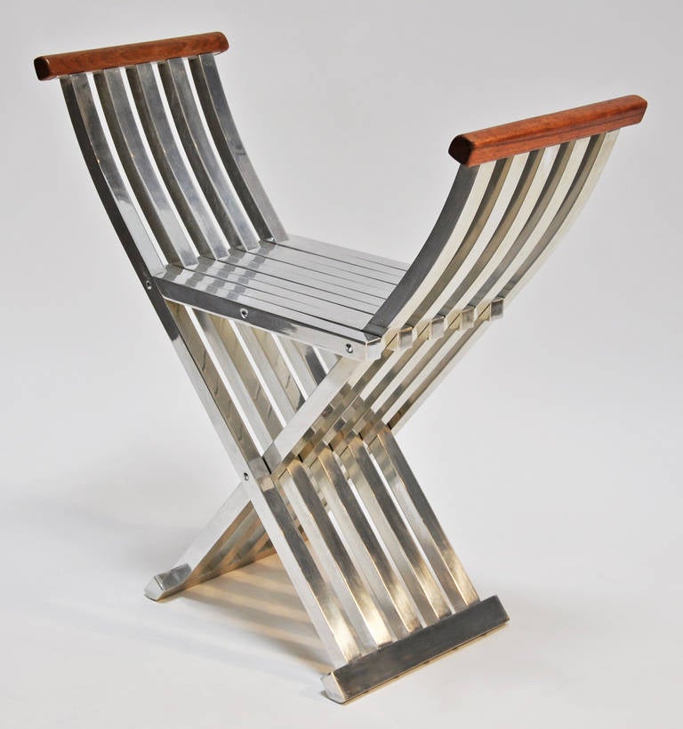 This solid aluminum folding seat or bench, with finished wood armrests was designed by American, John Vesey.  Top quality design and craftsmanship.