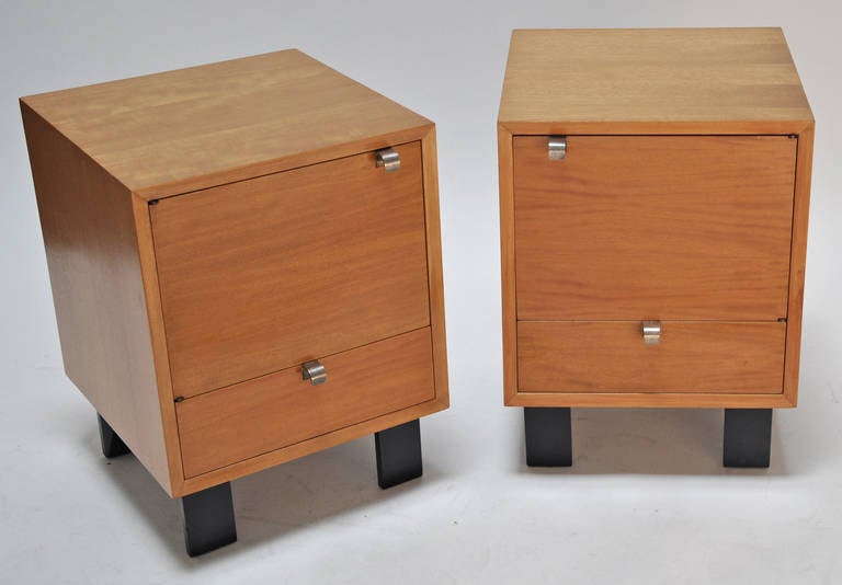 Matching pair of night stands or sofa cabinets by American designer, George Nelson for Herman Miller. Each features a drawer, swing out door with storage. Aluminum pulls. Original condition. Clean and ready for use. Price is for the pair.