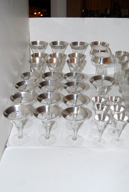 Nice assortment of pieces comprised of various martini, wine, cordial, champagne, rocks, collins glasses and 3 bowls.<br />
PRICE IS NET <br />
<br />
From back on left side<br />
4 water goblets-$160<br />
6 Wines-$220<br />
12 Martinis