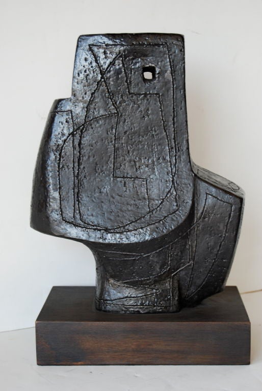 This is a striking yet somber sculpture by the famed NYC abstract expressionist.  It is cast plaster with incisions throughout and mounted on a stained wood base.<br />
<br />
