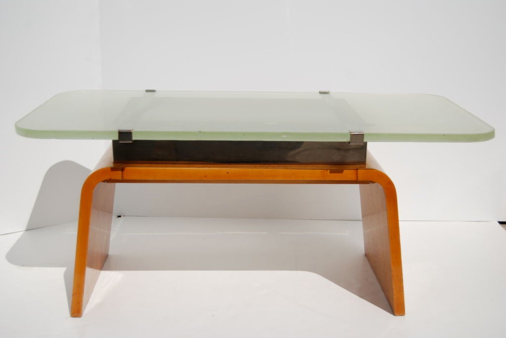 This lovely table has its original green hued Saint-Gobain glass top mounted to a burl wood base with chrome hardware.