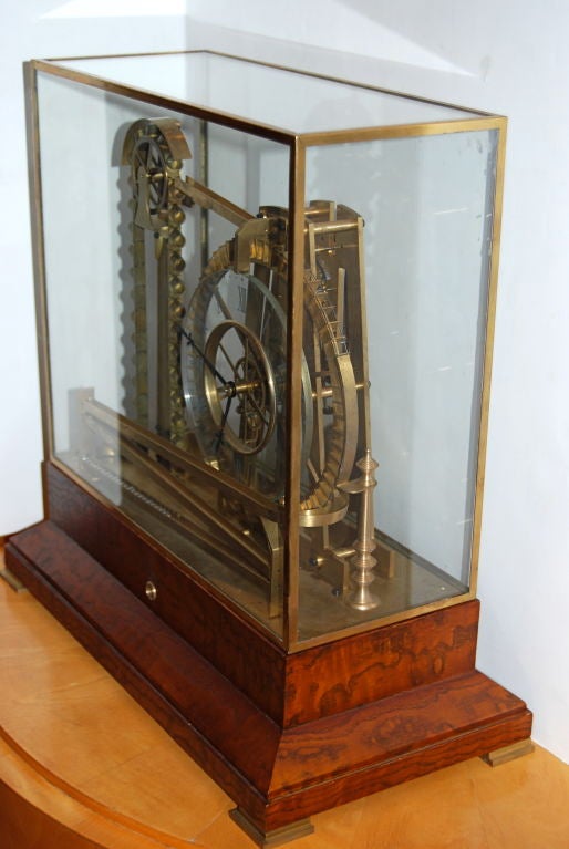 This clock is beautifully made of brass and Japanese ash.  The steel ball bearings are ferried up the bucket lift, roll down the ramp to the large wheel then run along the switchbacks and back to the bottom.  It comes with glass case top and key.