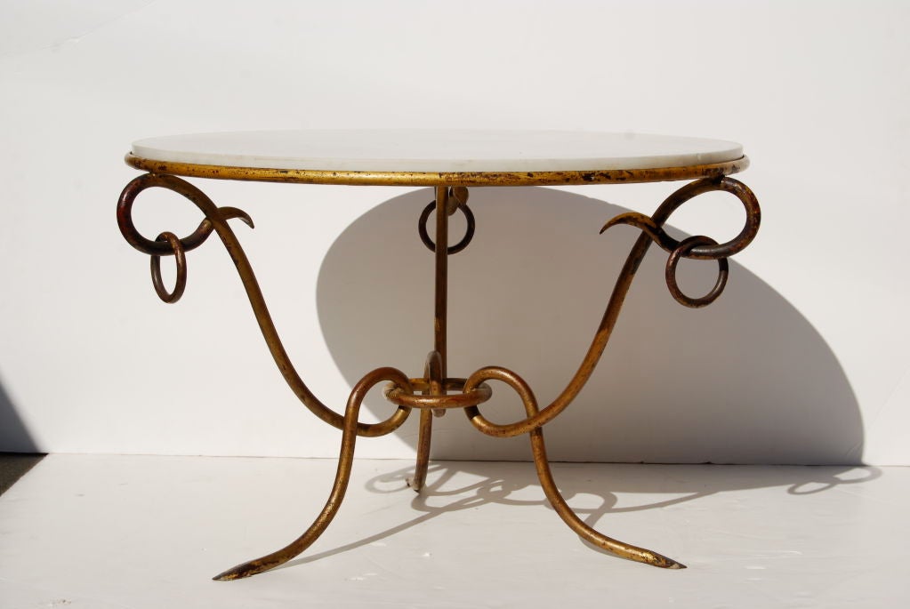 Such a gorgeous table. Great patina and original honed white marble top.
The epitome of French forties fer forge tables.