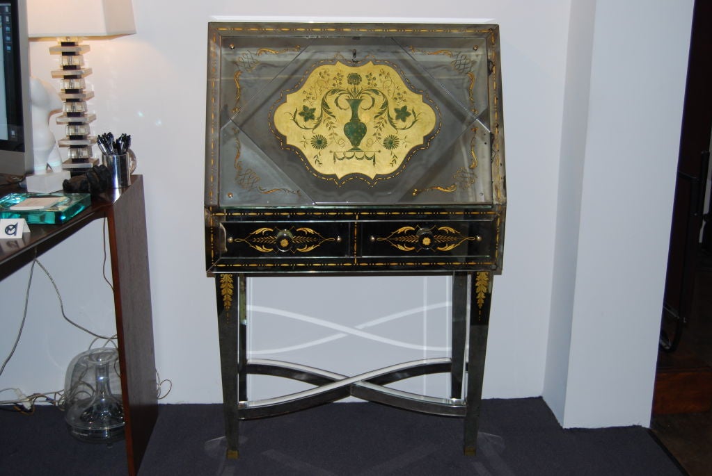 This accomplished French designer was a a master of the art of verre églomisé. He often collaborated with other well-known designers such as Arbus and Poillerat.
This beautiful drop front secretaire is completely sheathed in verre églomisé mirror