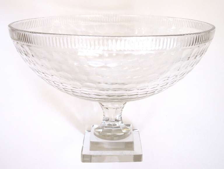 A large-scaled and good quality Irish cut-crystal bowl; the etched rim above a cut bowl; raised on a splayed support over a stepped square plinth