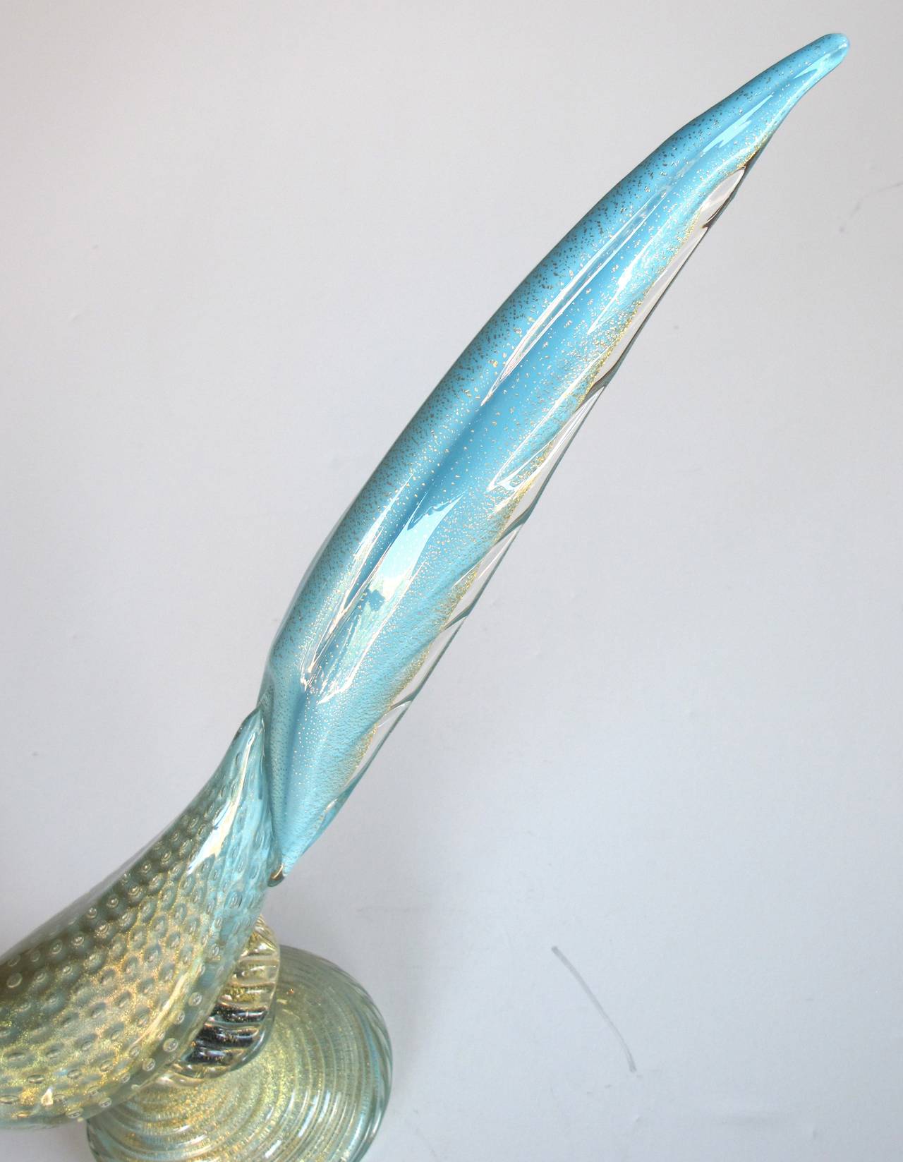 A graceful pair of Murano 1950's art glass birds by Barbini, each elegantly perched bird with dramatic tail; all in a pale blue and gold aventurine glass