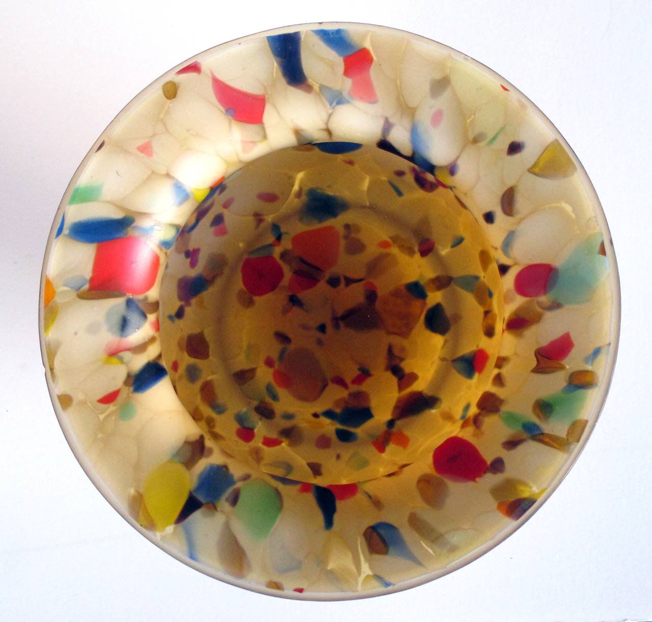 A colorful English 1960's end-of-day glass compote; with everted lip above a compressed bowl; the speckled glass made up of colorful glass bits remaining at the end of the day