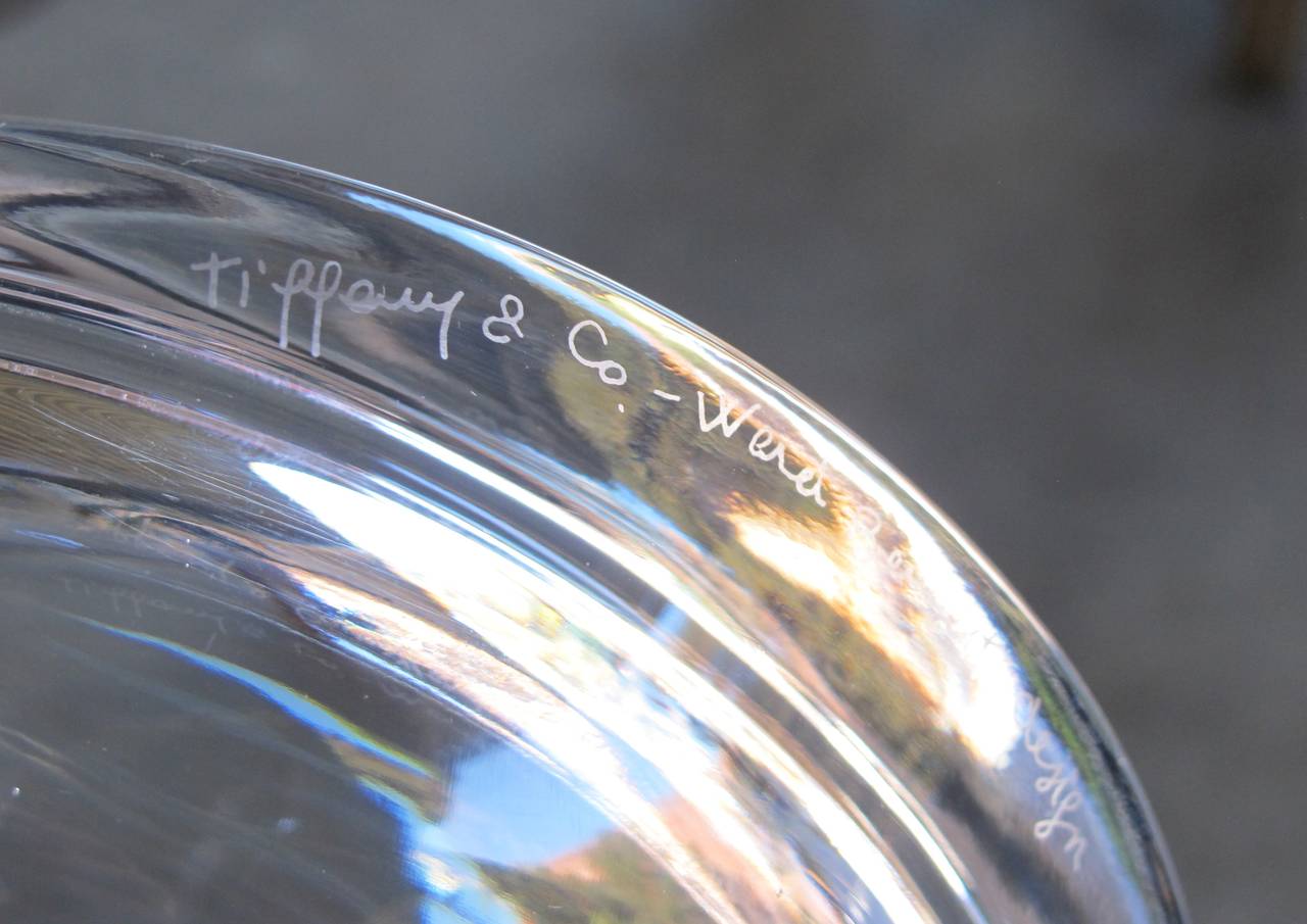 A rare Tiffany & Co. glass bowl; inscribed 'Tiffany & Co. Ward Bennett design. The thick circular clear glass bowl with bevelled edge.