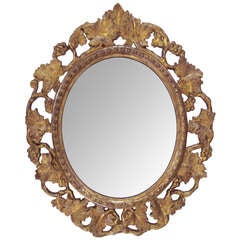 A Charming Napoleon III Oval-Form Reticulated Carved Giltwood Mirror with Grapevine Motif