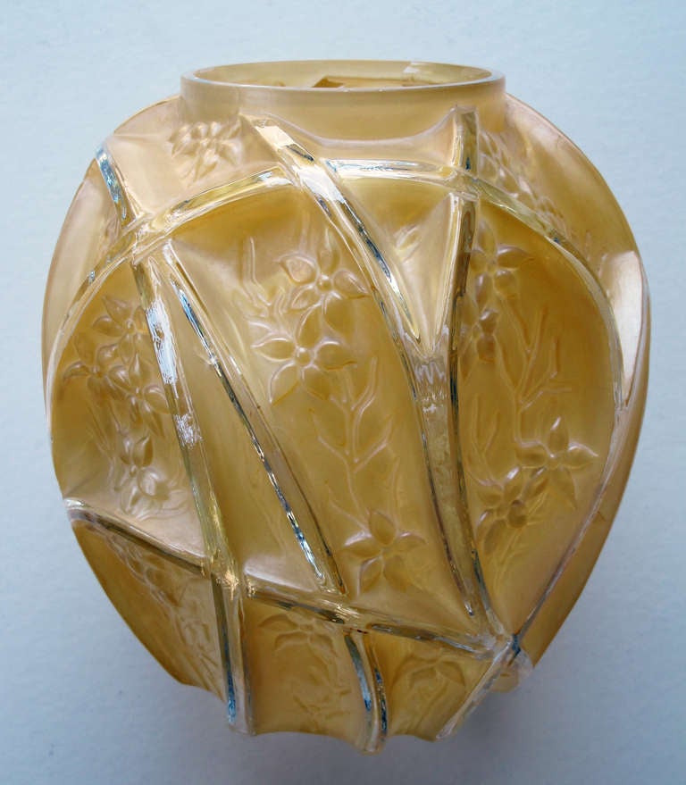 A well-executed American art deco Consolidated Glass honey-colored '700 Line' vase; with short neck above a textured ovoid body divided by clear glass arcs creating foliate relief reserves