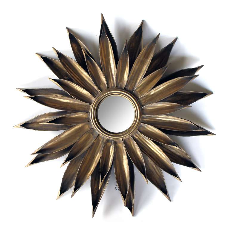 A large-scaled and vibrant French 1940's gilt-tole foliate starburst convex mirror; centering a convex mirror surrounded by a double-layered frame of gilt-tole leaves