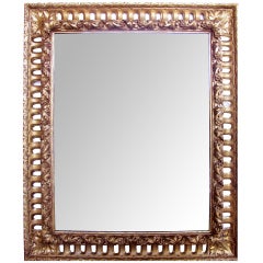 A Richly Carved Italian Baroque Style Giltwood Mirror with Reticulated Frame