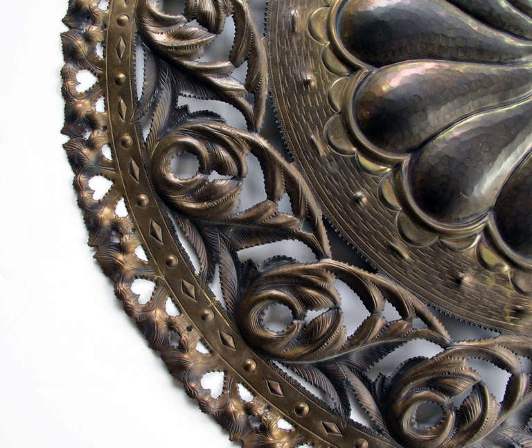 A massive and well-executed Italian 1960's reticulated hand-hammered brass charger with pinwheel design; stamped 'Casagrande, Borgo Trento, Italia'; the large circular wall hanging centering a large pinwheel within a pierced foliate border