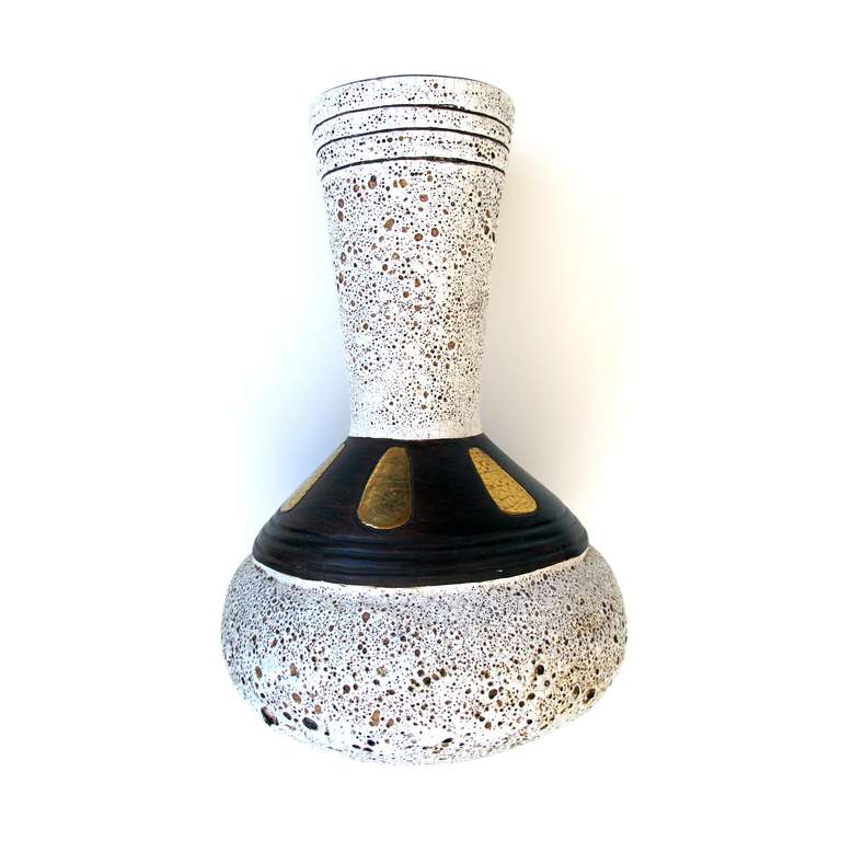 A large-scaled American 1960's art pottery vase; with paper label 'Jaru California'; the bulbous vessel in an ivory-colored pitted glaze with brown perimeter band and gilt highlights