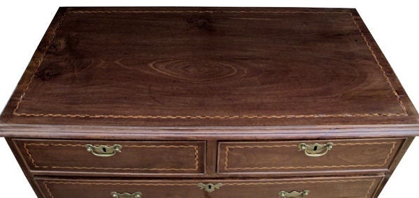 A handsome English George III mahogany 5-drawer chest with inlaid compass rose and chevron stringing; the rectangular top above a conforming body fitted with 2 short drawers over 3 long drawers all raised on bracket feet; top and drawer fronts with