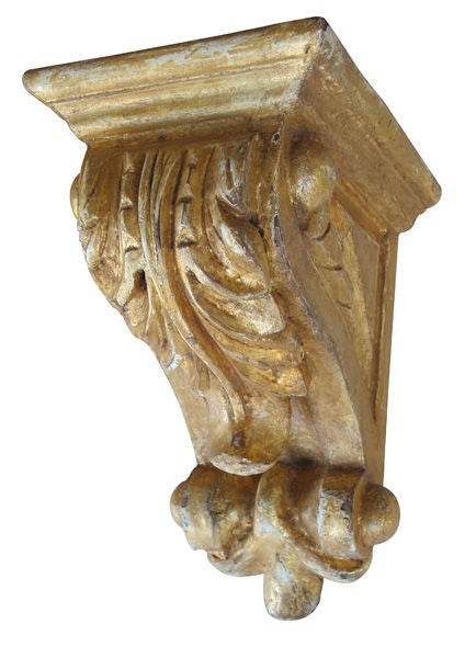 A well-carved pair of American Classical revival giltwood corbels or brackets (three available); each with rectangular shelf above a dramatically scrolling body adorned with an over-scaled acanthus leaf ending in a scrolling volute.