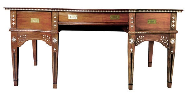 A rare and large-scaled Anglo-Indian mahogany 3-drawer writing desk with bone inlay; the well-figured rectangular top with arbelette front; the body fitted with 3 drawers with inset brasses; raised on 6 tapering square supports joined by spandrels;