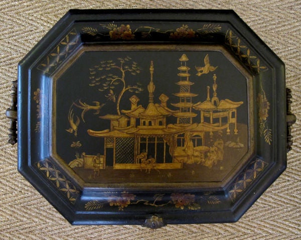 A rare and unusual English ebonized painted metal octagonal covered coal bin with chinoiserie decoration; by the Coalbrookdale Foundry, Telford, England; the octagonal hinged lid with coved border above a flared body flanked by elaborate iron