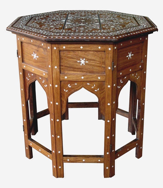 A well-crafted and good-scaled Anglo-Indian octagonal traveling table with fine bone inlay; the octagonal top centering a large bone inlaid star interspersed with stylized flower heads; surrounded by a foliate vine; raised on a conforming base with